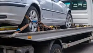 Loaded broken car on a tow truck. Car being towed. Damage vehicle after crash accident