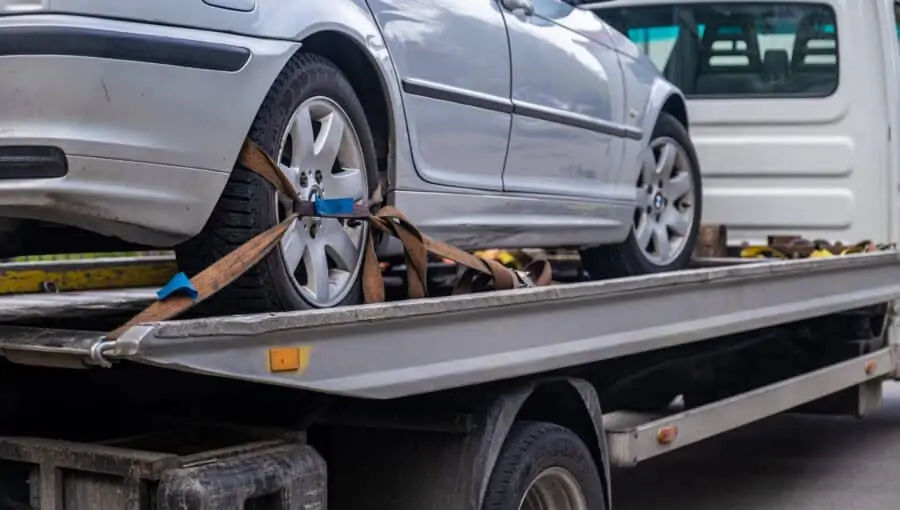 damaged car loaded on a tow-truck