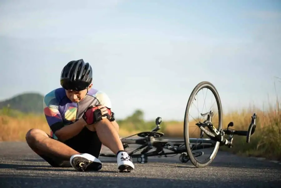 Biker clutching knee