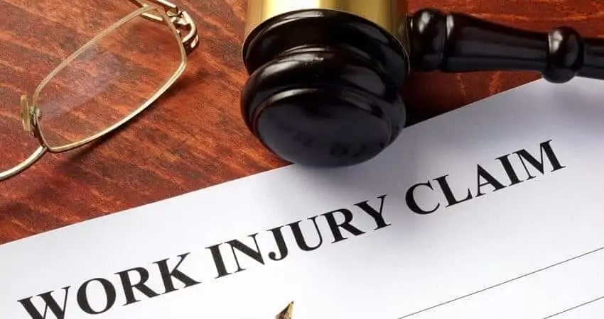 Work injury claim form, eyeglasses and gavel