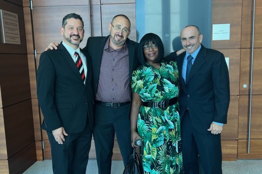 Ginnis, Krathen, & Zelnick attorneys Miguel Amador and Ross Zelnick with client